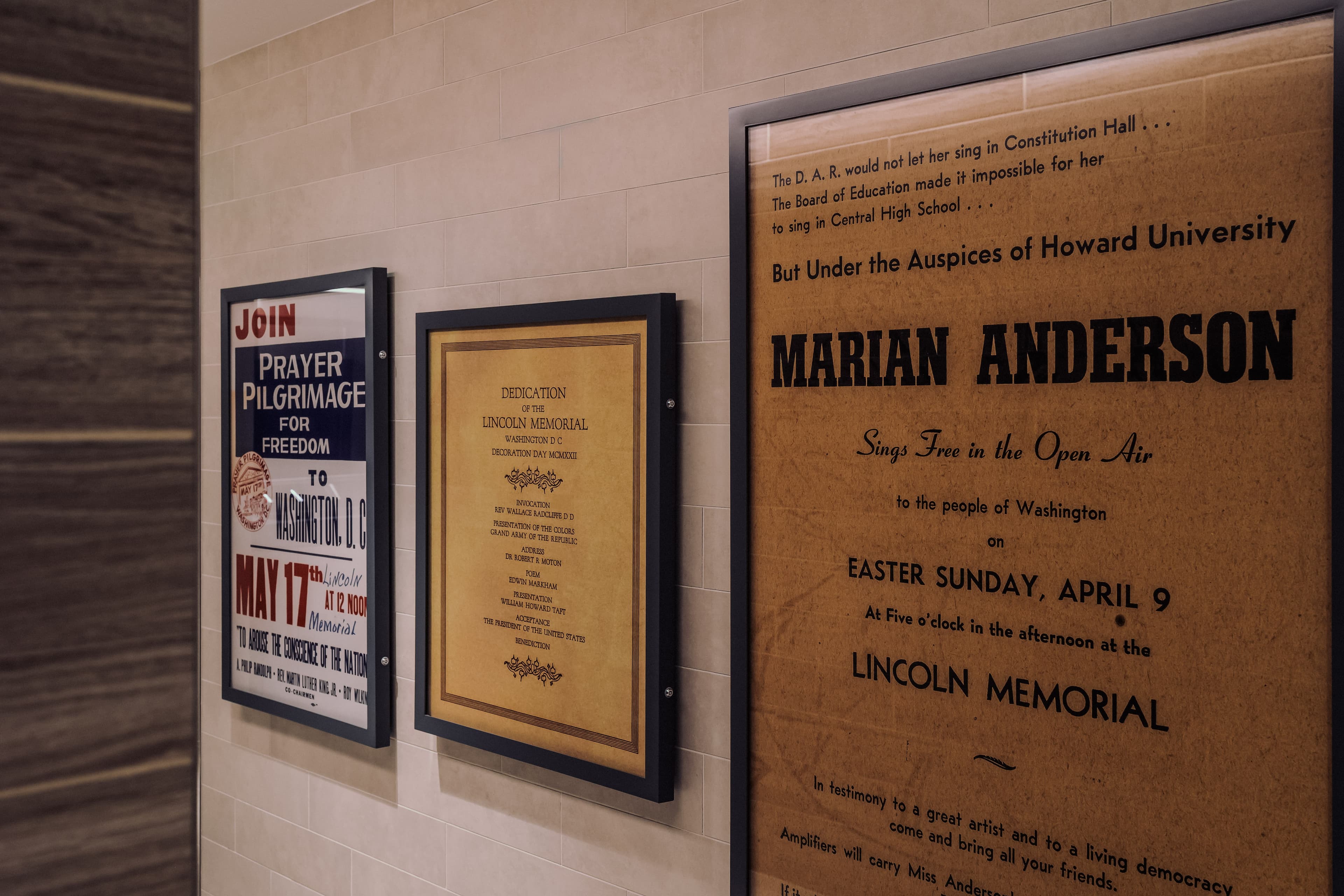 Several posters and fliers for historic events that happened at the Lincoln Memorial are framed on a wall. The closest one is a flier for the Marian Anderson opera concert.