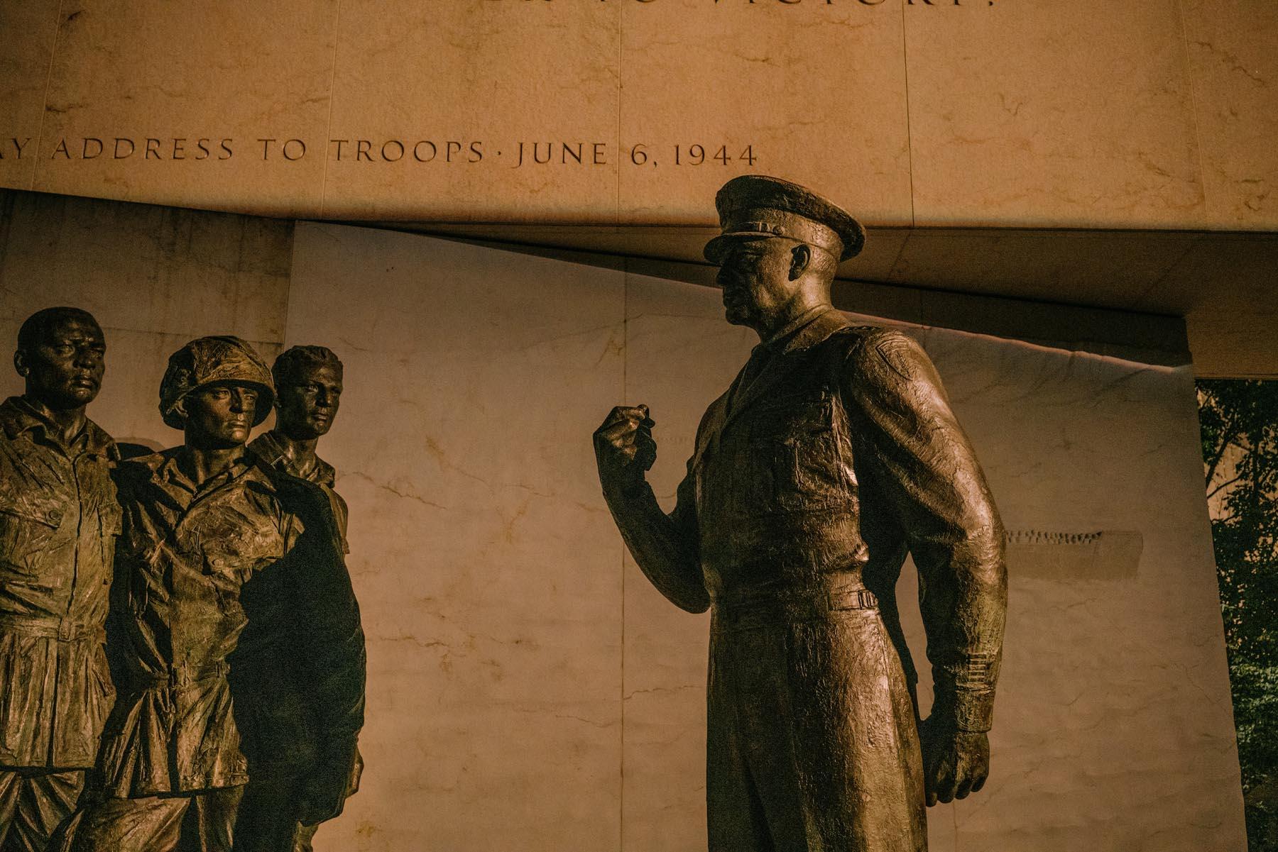 Statue of General Eisenhower addressing a group of soldiers, with his iconic hand gesture symbolizing leadership and resolve.