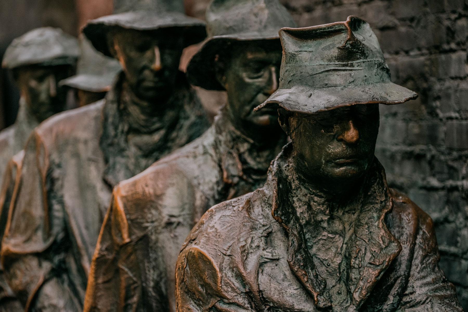 Statues of men in a bread line at the Franklin Delano Roosevelt Memorial, symbolizing the struggles of the Great Depression.