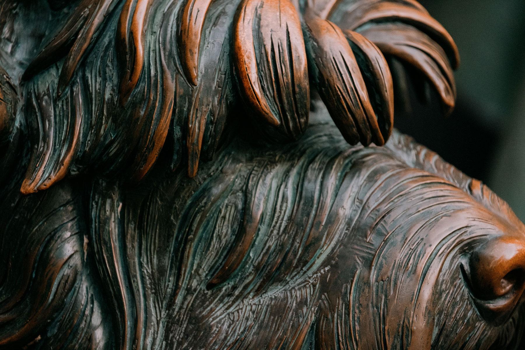 Statue of Fala, Franklin Delano Roosevelt’s Scottish Terrier, with detailed fur texture sitting on a stone base.