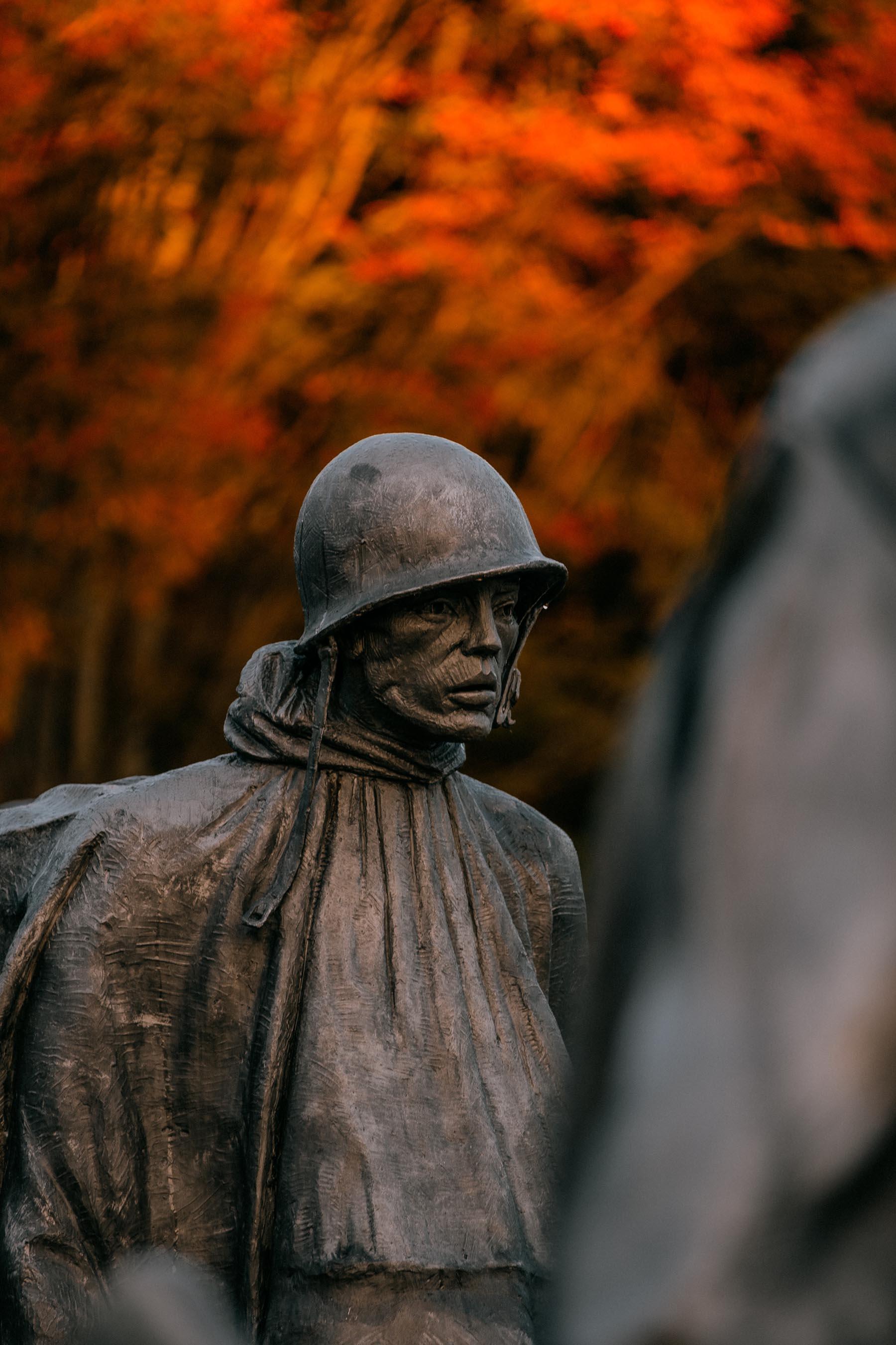 Side perspective of the soldier statues at the Korean War Veterans Memorial, emphasizing their expressions and detailed uniforms.