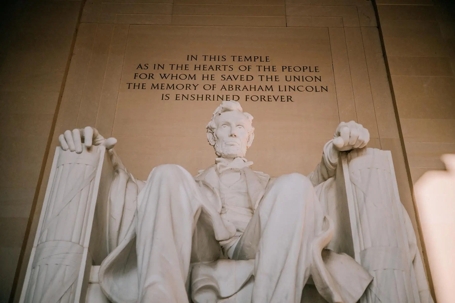 The statue of Abraham Lincoln seated in a chair, with the inscription above reading "IN THIS TEMPLE AS IN THE HEARTS OF THE PEOPLE FOR WHOM HE SAVED THE UNION THE MEMORY OF ABRAHAM LINCOLN IS ENSHRINED FOREVER.